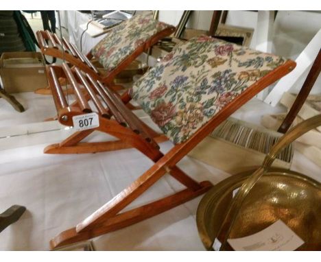A gout stool with tapestry cover