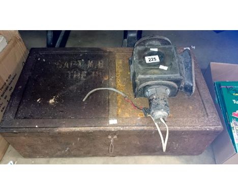 A tin trunk and a carriage lamp