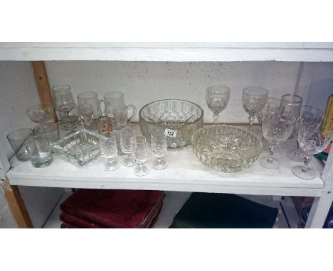 A shelf of assorted glassware