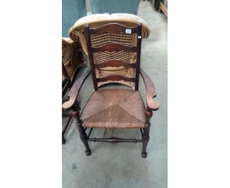 An oak ladder back carver chair
