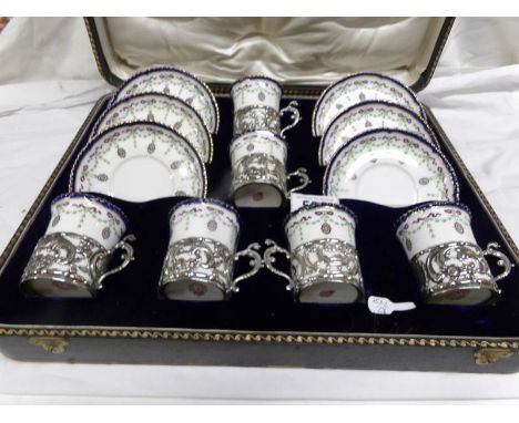 A cased set of Royal Worcester William Comyns 1905 coffee cans with silver holders.
 
This is in fair condition
2 saucers hav