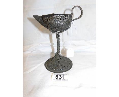 An early fretwork candleholder as a Genie lamp