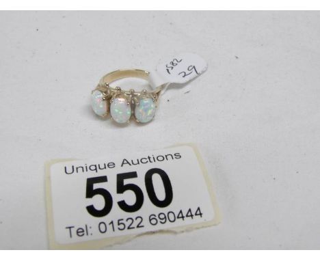 A large 3 stone yellow gold and opal ring, size K