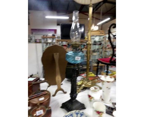 An oil lamp with tapered spelter column and blue glass font