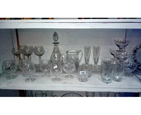 A shelf of assorted glass ware