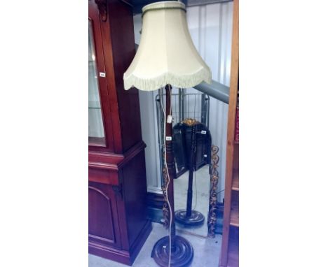 A wooden standard lamp