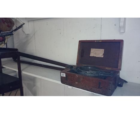 A cased brass compass with stand