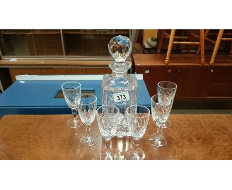 A cut glass decanter and 6 glasses