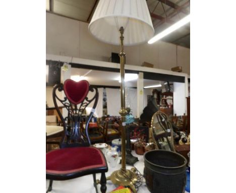 A Victorian brass standard lamp converted to electric