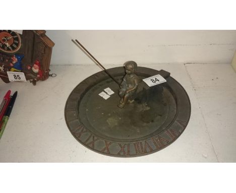 A metal sundial surmounted boy
