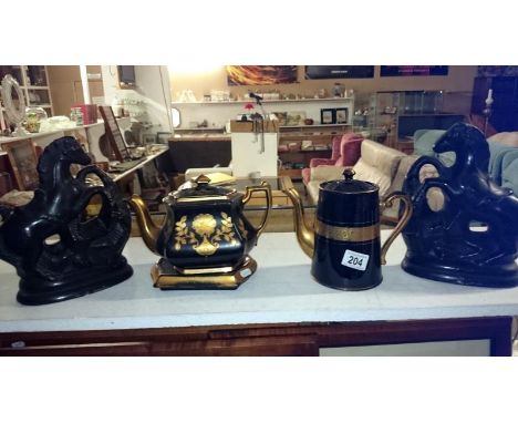 A Mourning ware teapot on stand and a teapot