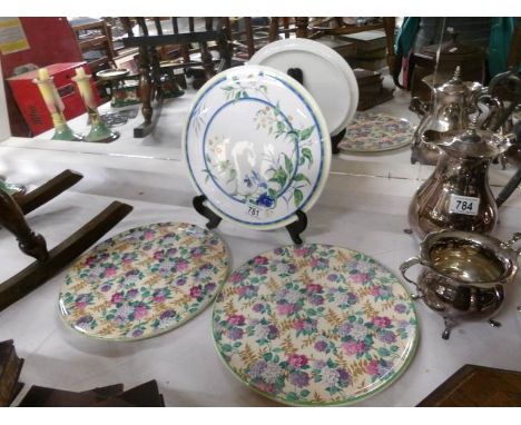 A pair of ceramic cake plates and one other