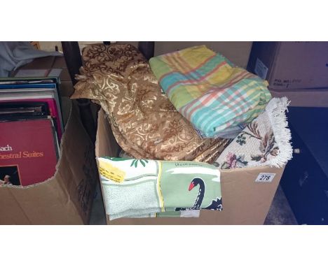 A box of table cloths and curtains etc