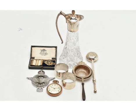 AN ASSORTMENT OF SILVER ITEMS, to include a pair of plain polished silver napkins, hallmarked Birmingham, a silver tea strain