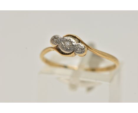 A YELLOW AND WHITE METAL THREE STONE DIAMOND RING, three small single cut diamonds, star set in a white metal mount, yellow m