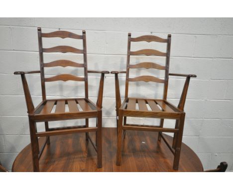 AN ERCOL ELM PEDESTAL DINING TABLE, with a single additional leaf, extended length 149cm x 111cm x depth 98cm x height 73cm a