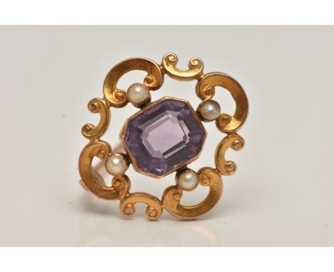A YELLOW METAL AMETHYST AND SEED PEARL BROOCH, open work scrolling brooch set with a central emerald cut amethyst collet set,