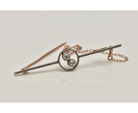 A YELLOW METAL DIAMOND BAR BROOCH, polished bar with open work centre piece set with two old cut diamonds, each milgrain set,