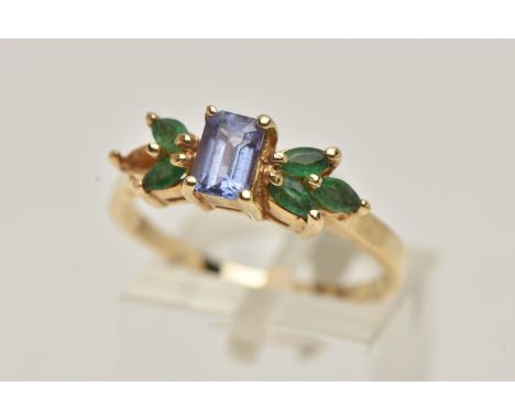 A TANZANITE AND EMERALD RING, rectangular cut tanzanite set with marquise cut emeralds, prong set in yellow metal, stamped 14