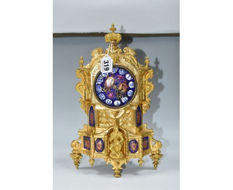 A SECOND HALF 19TH CENTURY FRENCH GILT FIGURAL MANTEL CLOCK, the enamel dial with raised Roman numerals and oval portraits of