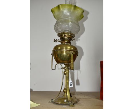 AN ARTS &amp; CRAFTS BRASS AND COPPER OIL LAMP IN THE STYLE OF W.A.S. BENSON, the frilled green and clear shade acid etched w