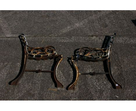 A pair of 19th century cast iron childs bench ends, ends only, 41cm wide 70cm high