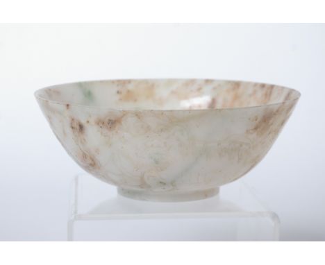 A pair of Chinese mutton fat jade bowls each with incised decoration of dragons to the exterior each 14cm diameter 