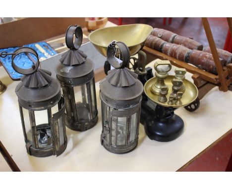 A set of three small tin lanterns each with six glazed panels (not marked), a set of pan scales with set of six graduated bra