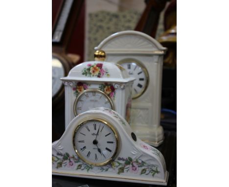 A reproduction wall clock, three ceramic cased mantel clocks and a banjo barometer