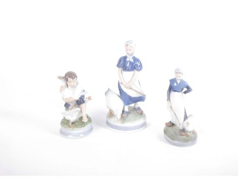 Four Royal Copenhagen figurines all geese with children, a large R/C model of two cockerel's (23cm high) and a Royal Doulton 