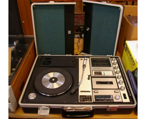 A vintage Sanyo solid state stereo music center in briefcase, with a Steepletone three speed turntable Provenance: from the e