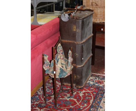 A bound trunk, walking sticks and a sewing basket on stand 