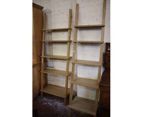 A graduated pair of modern waterfall ladder shelves in beech finish, both 103cm high, 50cm and 70cm wide