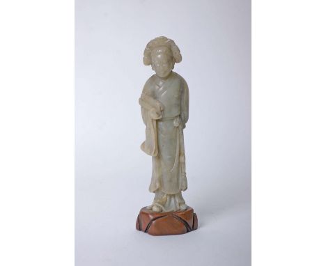 A Chinese carved soap stone figure, carrying a scroll on pedestal 24cm high   