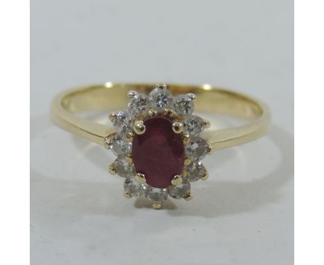 WILL COLLECT An unmarked gold ruby and diamond cluster ring, boxed