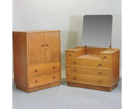 A 1940's light oak dressing table, 101cm, together with a matching cupboard
