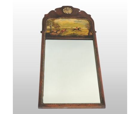 A Georgian style walnut and parcel gilt framed wall mirror, the rectangular plate having a gilt slip and painted above with a