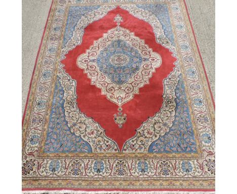 A Kashan woollen carpet, with a large central medallion on cream ground, 360 x 245cm 