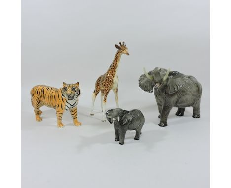 A Beswick model of a giraffe, 32cm tall, together with an elephant, another smaller and a tiger