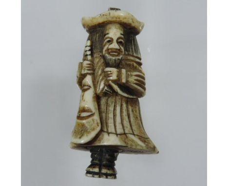 A Japanese carved stag antler netsuke, probably 18th century, in the form of a Dutchman holding a lute, 6.5cm tall 