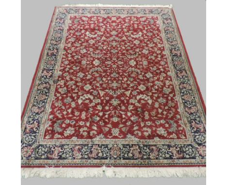 A Persian style carpet, with floral designs on a red ground, 240 x 170cm