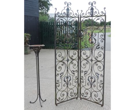 A wrought iron two fold screen, 202cm tall, together with an iron stand and lantern
