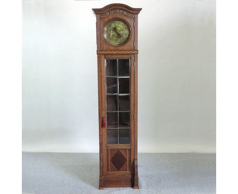 An early 20th century German oak cased longcase clock, with a brass dial, and bevelled glass door, 210cm tall