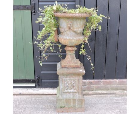 A cast iron campana shaped urn, on a plinth base, 116cm