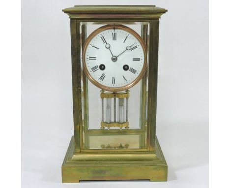 A late 19th century French brass cased four glass mantle clock, the white enamel dial with Roman hours, the twin train moveme