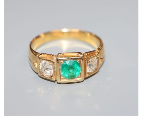 An 18ct gold, emerald and diamond set three stone ring, size O.