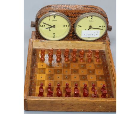 A bakelite travelling chess set and a snakeskin covered chess timer