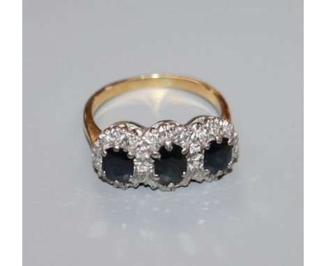 A yellow metal, sapphire and diamond set triple cluster ring, size O.