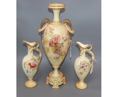 A Royal Worcester blush ivory amphora-shaped vase and a pair of similar Royal Bonn ewers, all with floral decoration, the Wor