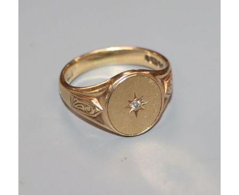 A 9ct gold and diamond gypsy-set ring with carved shoulders, size T.